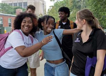 a group of students walking on campus