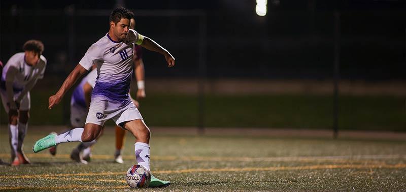 soccer player kicking the ball